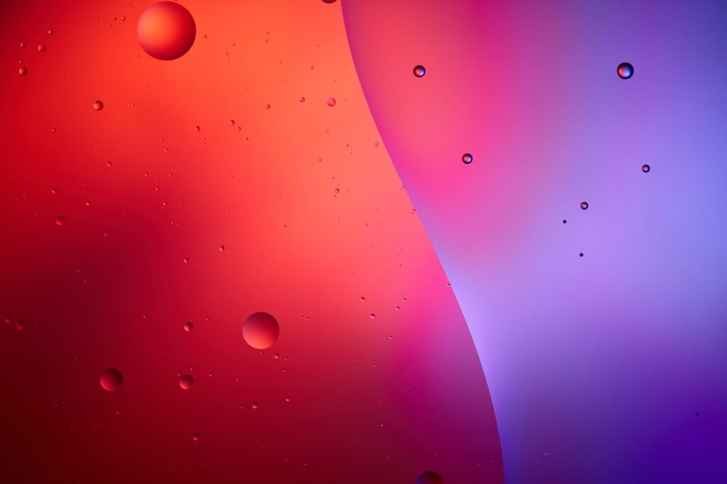 abstract texture from mixed water and oil bubbles in pink and purple color